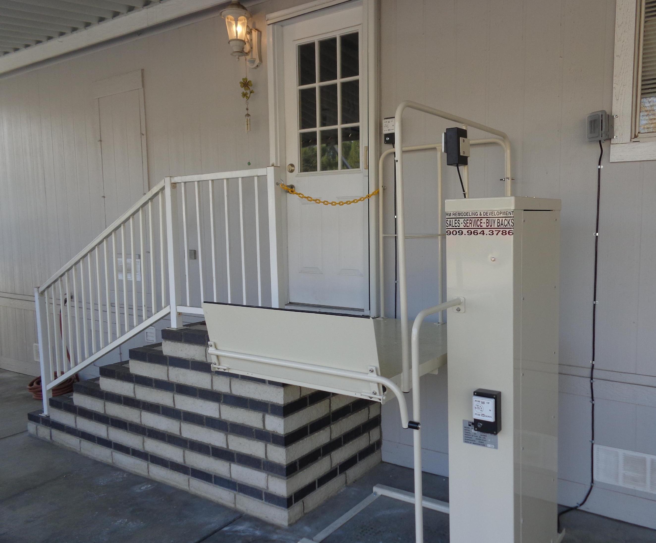 A stair lift is installed outside a house